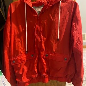 Red zip up wind breaker